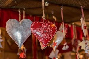 red heart christmas decorations at street market photo