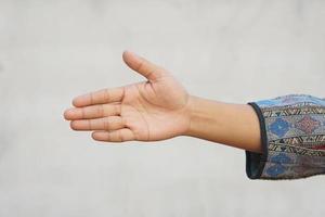 human hand reaching forward to shake hands photo