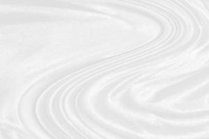 white silk textured cloth background,Closeup of rippled satin fabric with soft waves. photo