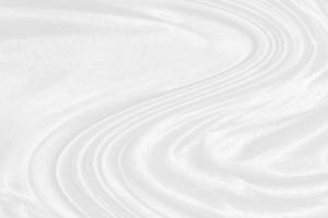 white silk textured cloth background,Closeup of rippled satin fabric with soft waves. photo