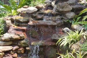 Waterfall in the garden with flowing water photo