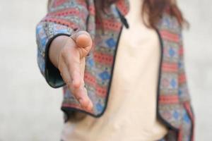 human hand reaching forward to shake hands photo