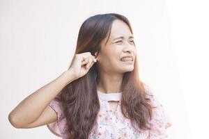 Asian woman having itchy ears photo