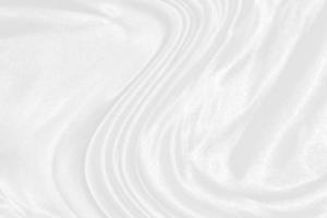 white silk textured cloth background,Closeup of rippled satin fabric with soft waves. photo