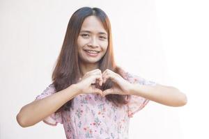 Asian woman hands making heart symbol photo