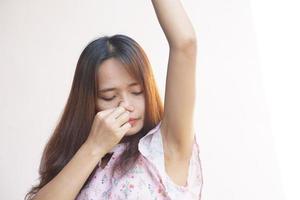 Asian woman smells of damp underarms photo