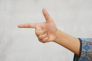 Human hand pointing a finger forward photo