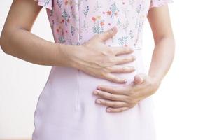 Asian woman having stomach pain from eating food photo