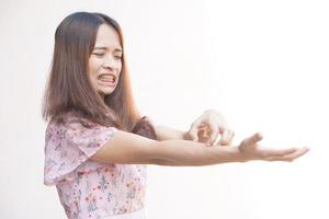 Asian woman having itchy skin on arm photo