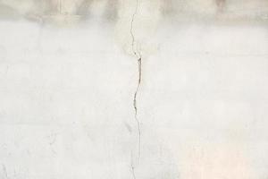 cement background with damaged cracks photo