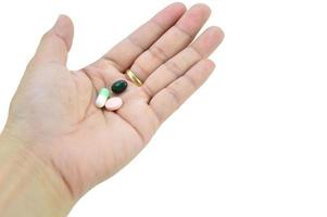 A hand with a pill on it, with clipping path photo