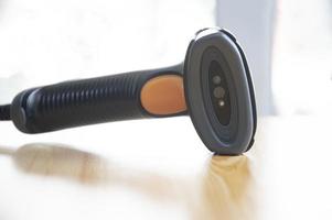 barcode scanner placed on a brown wooden floor photo