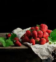 fresh ripe red strawberries on a gray linen napkin photo