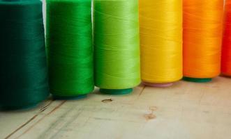 Several of colored spools of thread for sewing and embroidery photo