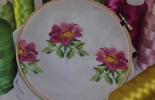 Embroidered cross flowers in wooden hoop photo