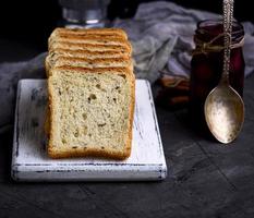 Square pieces of bread from white wheat flour with flax seeds photo