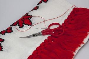 Traditional embroidered towel with red thread photo