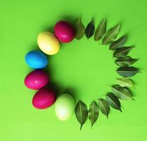 huevos de pascua y hojas verdes. roseta para texto. tarjeta. felicitaciones foto