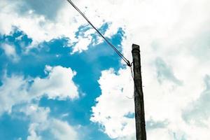 Power electric pole with line wire on colored background close up photo