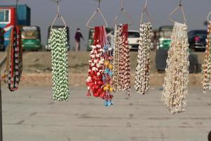 jewelry items made of sea snails displayed in seaside shops. photo