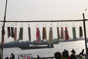 jewelry items made of sea snails displayed in seaside shops. photo