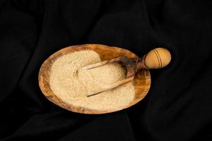 fresh ginger and dried ginger powder on olive wood photo