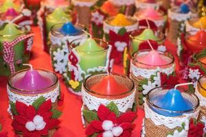 different 0colors candles christmas decorations at street market photo