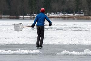 people playing hockey on frozen lake photo