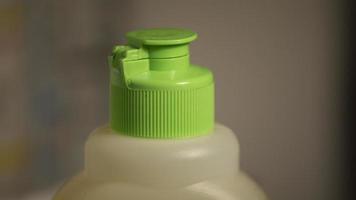 Green bottle cap. Bottle with detergent. Protective cover on detergent. photo