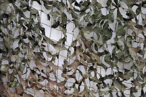 Close-up of a camouflage net for military use - background texture. photo