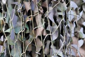 Close-up of a camouflage net for military use - background texture. photo