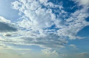 Beautiful view at sunbeams with some lens flares and clouds in a blue sky photo