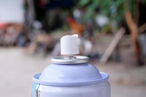 Head of a can of white spray paint on a blurred background. macro shot photo