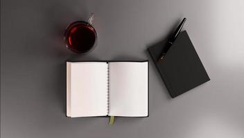 Top view of black notebook with pen and cup of tea on dark background photo