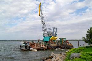 Luffing crane at the barge on water photo