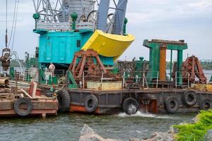 Luffing crane at the barge on water photo