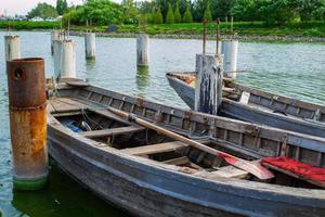 old wooden boats at the pier on green blooming water photo