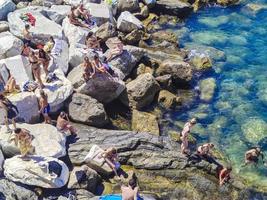 Travelogue of vacationers enjoying the beach on a warm day in Liguria photo