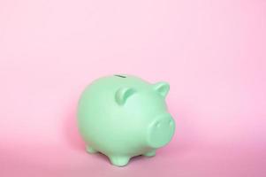 Piggy bank highlighted on pink background photo