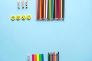 A set of bright stationery items on a blue background. Colour pencils photo