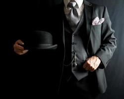 Portrait of Gentleman in Dark Sui Holding Bowler Hat. Vintage Style and Retro Fashion of Classic English Gentleman.