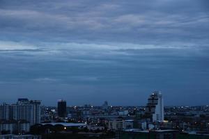 dark blue cloud with white light sky background and city light midnight evening time photo