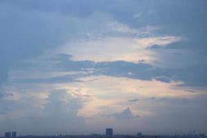 dark blue cloud with white light sky background and city light midnight evening time photo