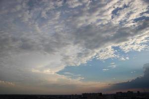 sunset dark blue cloud with white golden light sky background and city light midnight evening time photo