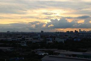 sunset dark blue cloud with white golden light sky background and city light midnight evening time photo