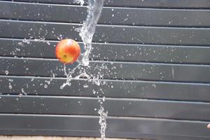 throw apple through  water steam fall photo