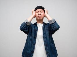 Sadness asian man jeans shirt feels disheartened,cry,headache isolated photo