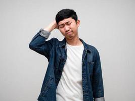 Sadness asian man jeans shirt feels disheartened,cry,headache isolated photo