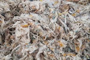 Waste recycling shredded plastic scrap pieces. Environmental concept. Eco-friendly lifestyle zero waste. Garbage sorting plant. Ecology reuse green world idea. Industry reduced pollution factory photo