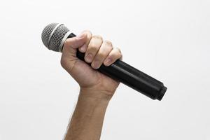 Hand holding microphone on white background photo